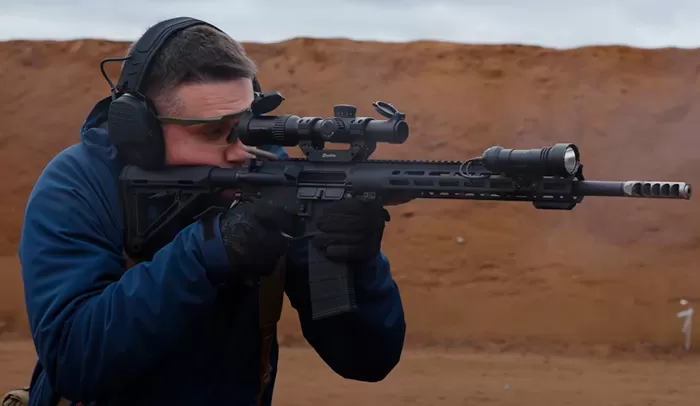 Человек стреляет из AR15 с оптикой